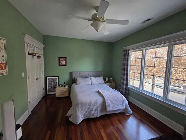 a view of a room with a large window and furniture
