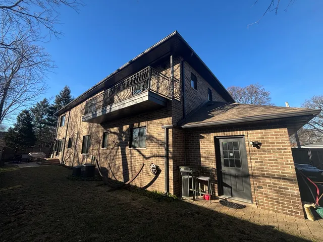 a view of a brick wall next to a brick building