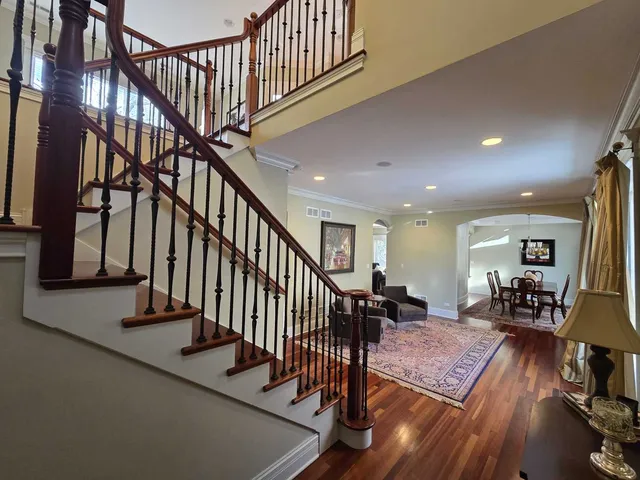 a view of entryway livingroom and hall with wooden floor