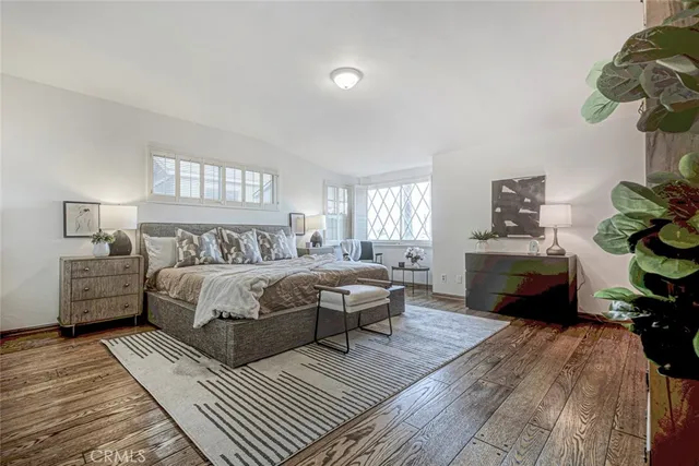 a bedroom with a bed table and window