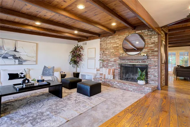 a living room with fireplace furniture and a large window