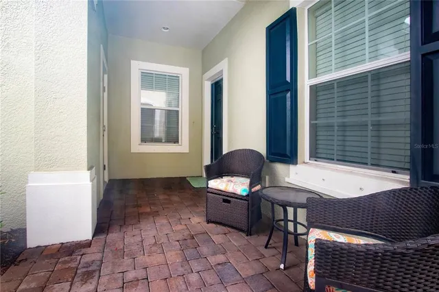 a kitchen with stainless steel appliances granite countertop a stove and a view of living room