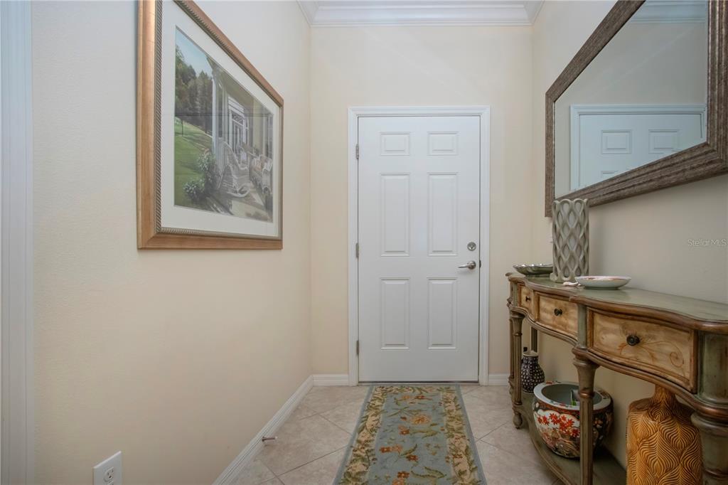 4920 Maymont Park Circle Bradenton, FL 34203 - Photo 12 of 59 a view of an entryway with table and mirror