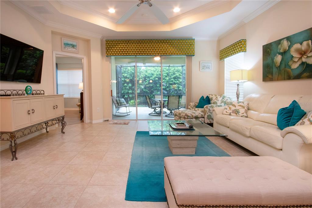 4920 Maymont Park Circle Bradenton, FL 34203 - Photo 20 of 59 a living room with furniture fireplace and a flat screen tv