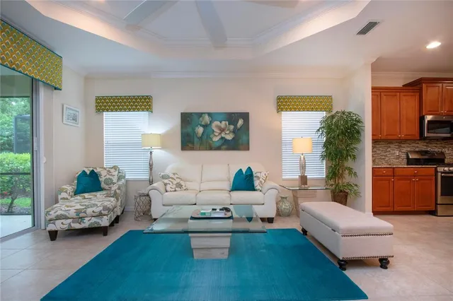 a living room with furniture and a dining table with kitchen view