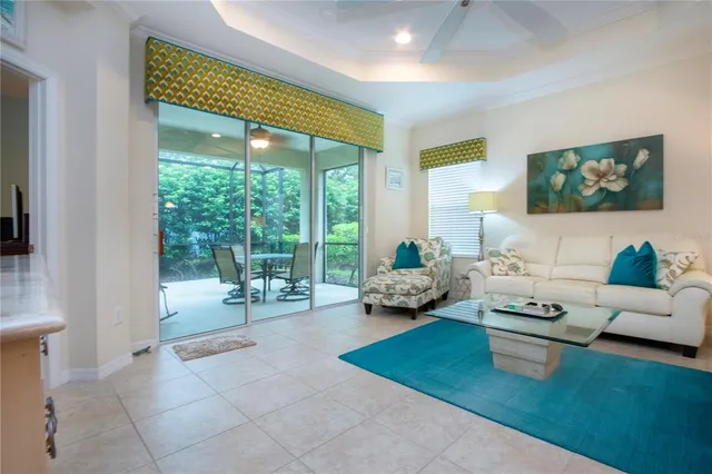 a living room with furniture and a dining table with kitchen view