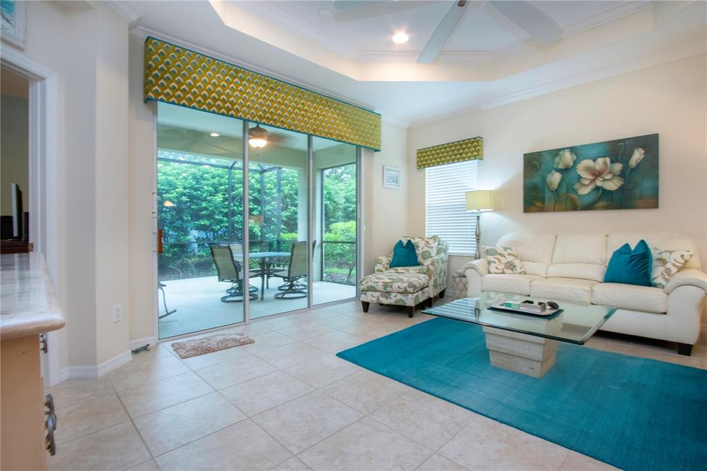 4920 Maymont Park Circle Bradenton, FL 34203 - Photo 23 of 59 a living room with furniture and a large window