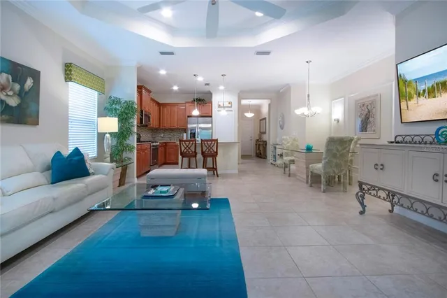 a kitchen with stainless steel appliances granite countertop a sink a stove a refrigerator cabinets and chairs