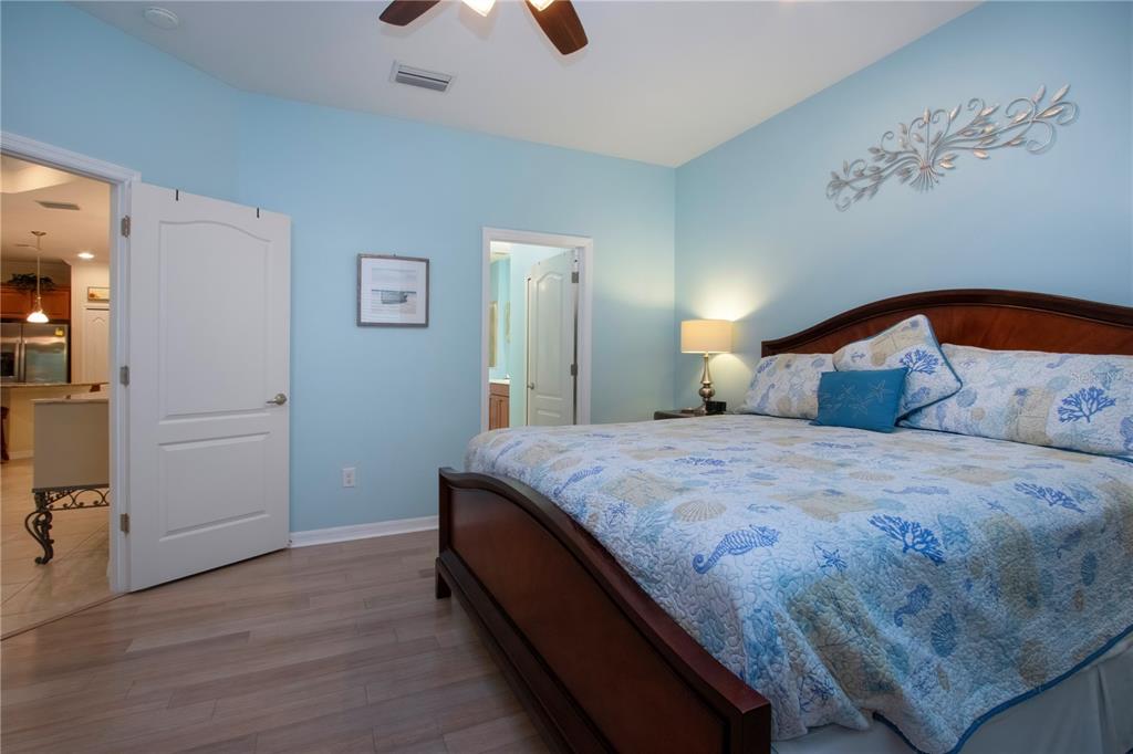 4920 Maymont Park Circle Bradenton, FL 34203 - Photo 36 of 59 a bedroom with a bed and a painting on the wall