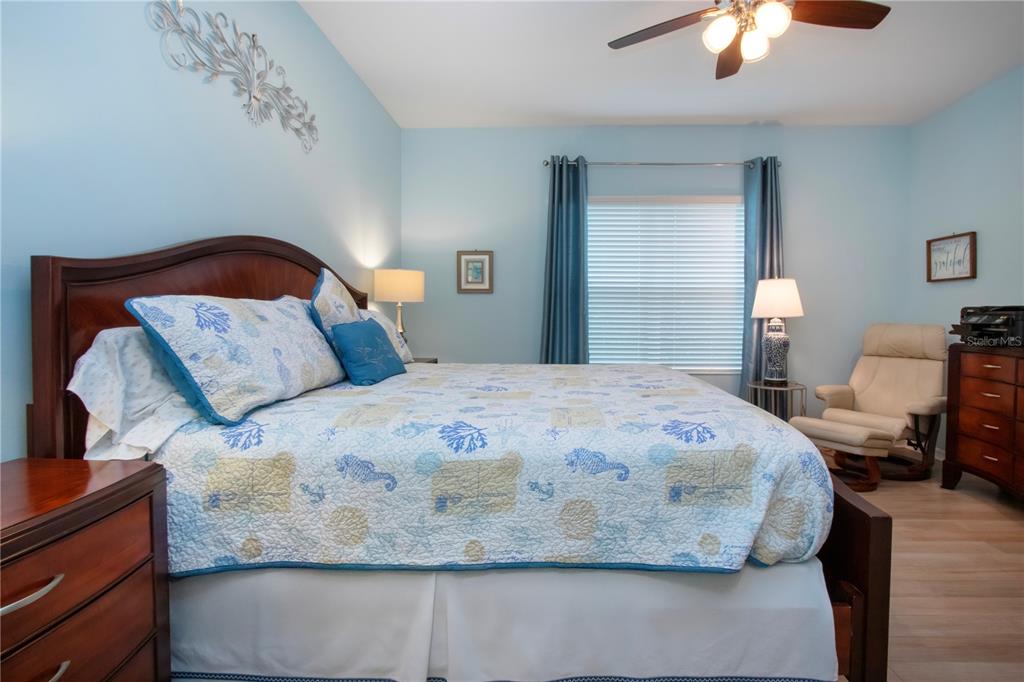 4920 Maymont Park Circle Bradenton, FL 34203 - Photo 40 of 59 a bedroom with a bed and a chandelier