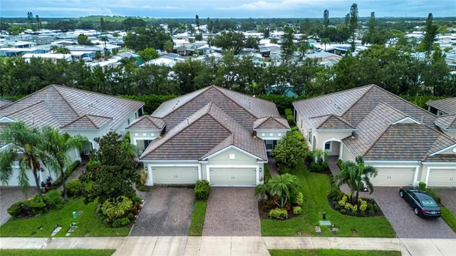 an aerial view of house with yard and mountain view in back