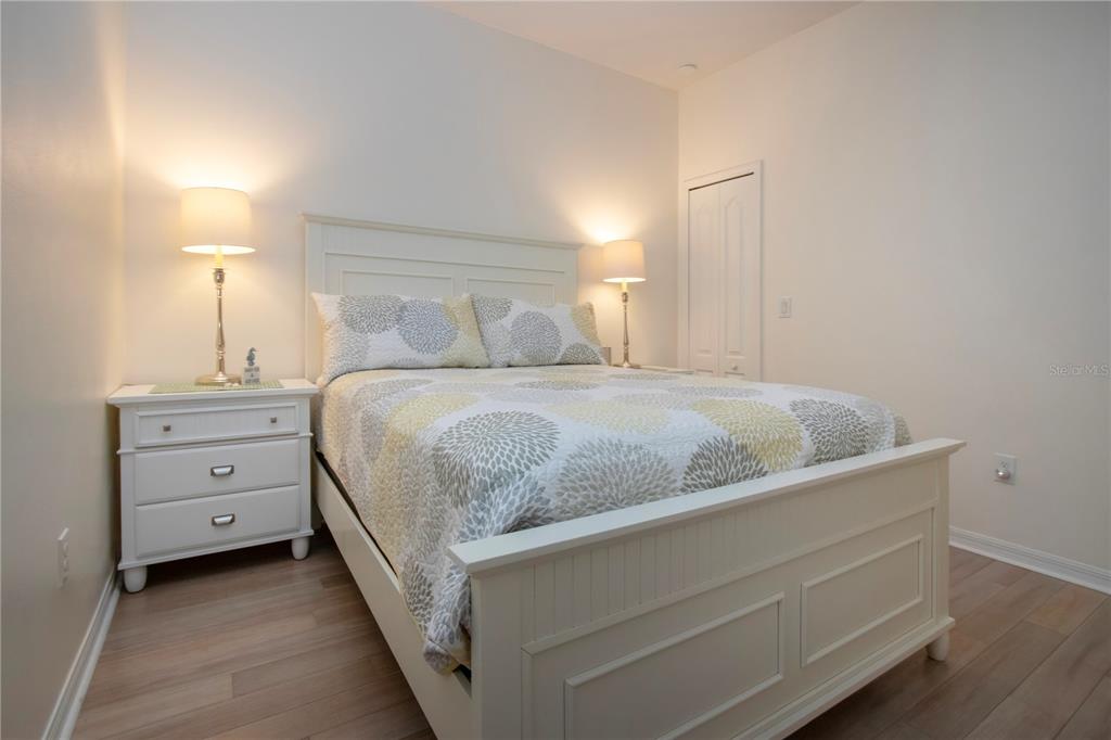 4920 Maymont Park Circle Bradenton, FL 34203 - Photo 51 of 59 a bedroom with a bed and a lamp