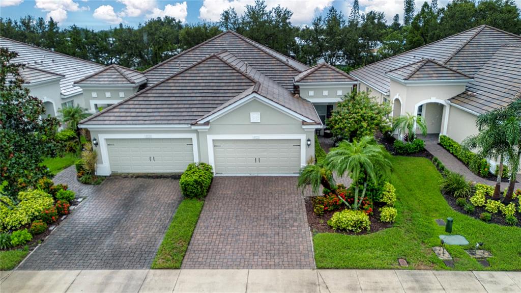 4920 Maymont Park Circle Bradenton, FL 34203 - Photo 8 of 59 a front view of a house with garden