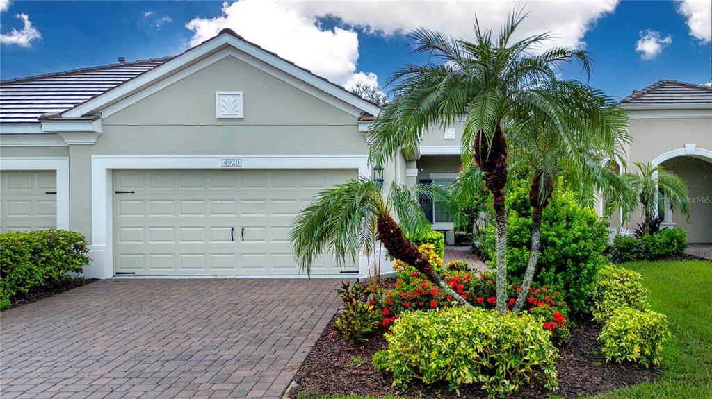 4920 Maymont Park Circle Bradenton, FL 34203 - Photo 9 of 59 a front view of yellow house with a small yard