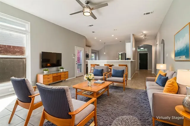 a bedroom with a balcony a bed and a potted plant