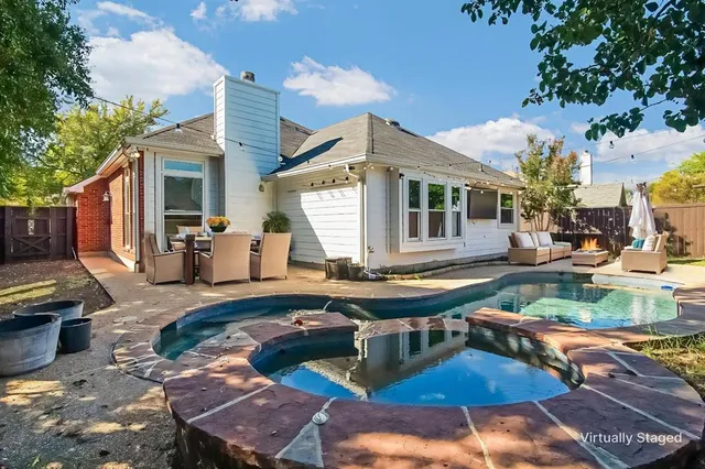 a view of a house with backyard and sitting area