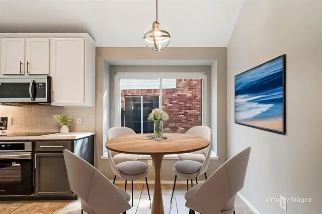 a kitchen with kitchen island granite countertop a refrigerator and a sink