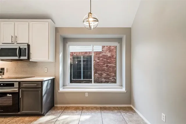a living room with furniture kitchen and a flat screen tv