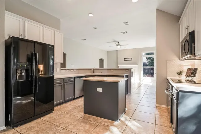a view of an empty room with a fireplace and a window