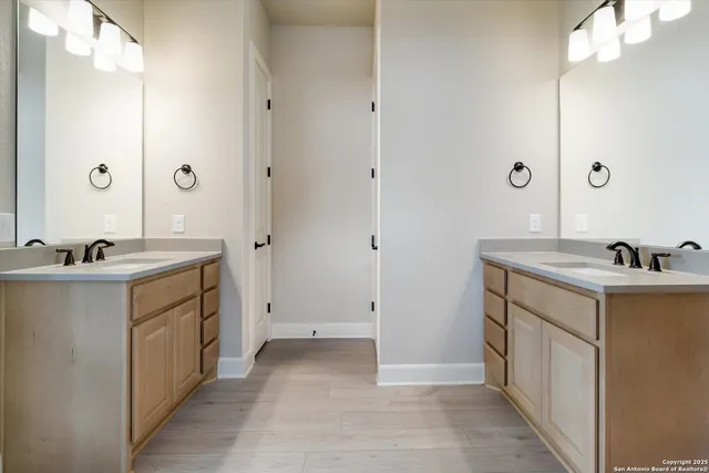 a spacious bathroom with a sink double vanity and a mirror