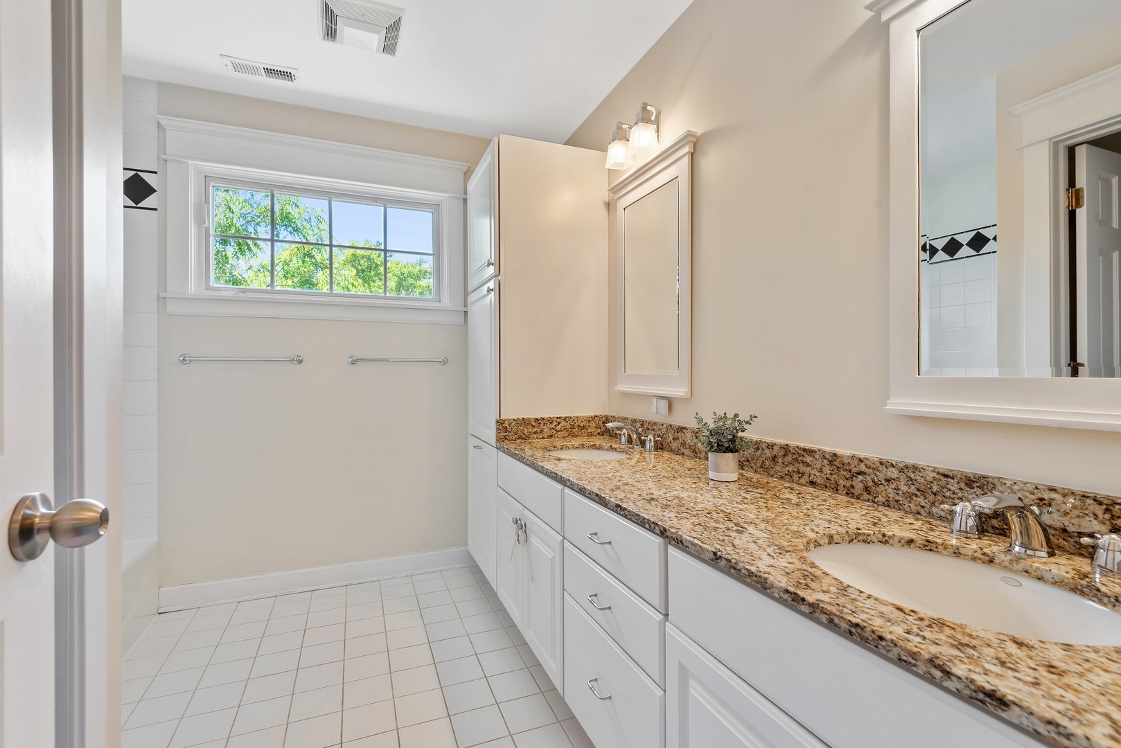 989 Willow Road Winnetka, IL 60093 - Photo 22 of 30 a bathroom with a granite countertop sink and a window