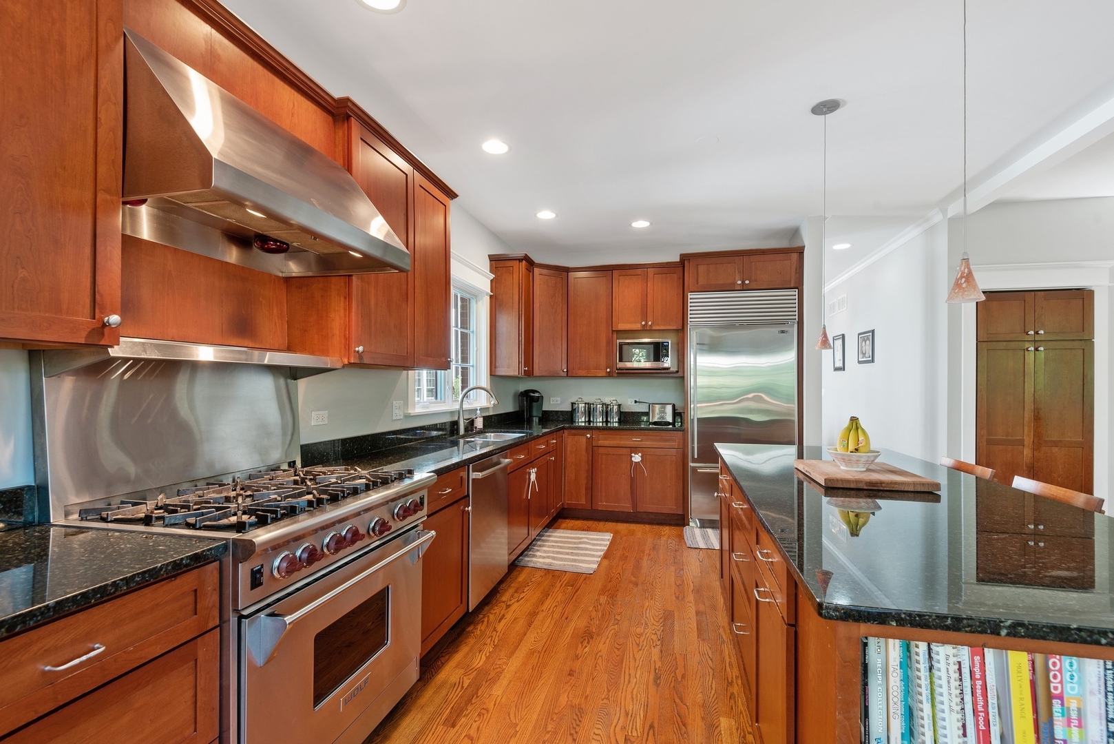 989 Willow Road Winnetka, IL 60093 - Photo 8 of 30 a kitchen with stainless steel appliances granite countertop a stove and a refrigerator