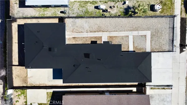 a view of a house with a patio and a yard