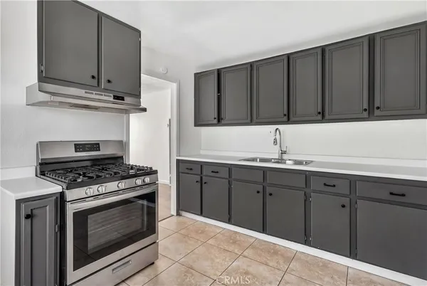 a kitchen with granite countertop a stove and a sink