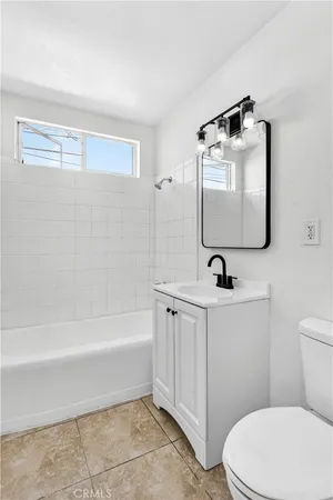 a view of empty room with wooden floor and ceiling fan