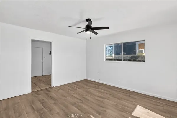 a view of an empty room and wooden floor