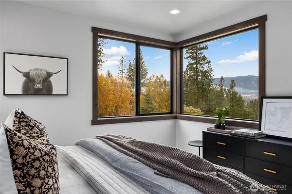 a living room with a large window and outer view