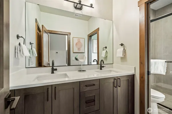 a bathroom with a double vanity sink and a mirror