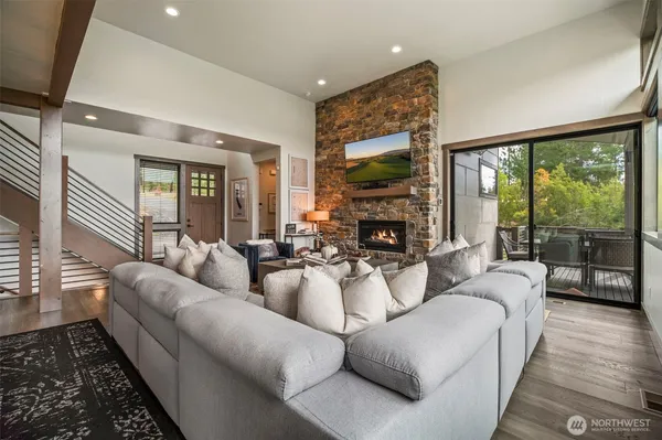 a living room with furniture and a floor to ceiling window