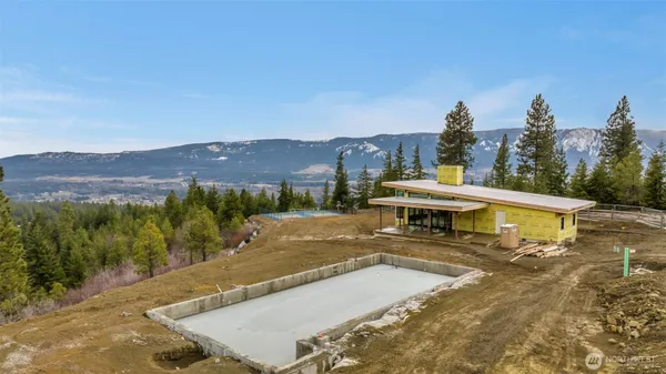 a view of swimming pool with a yard and mountain view