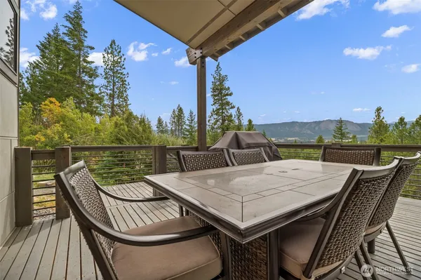 a view of a roof deck with furniture