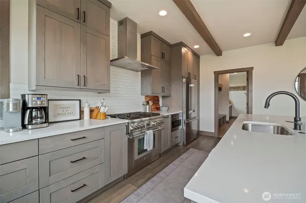 a kitchen with white cabinets and stainless steel appliances