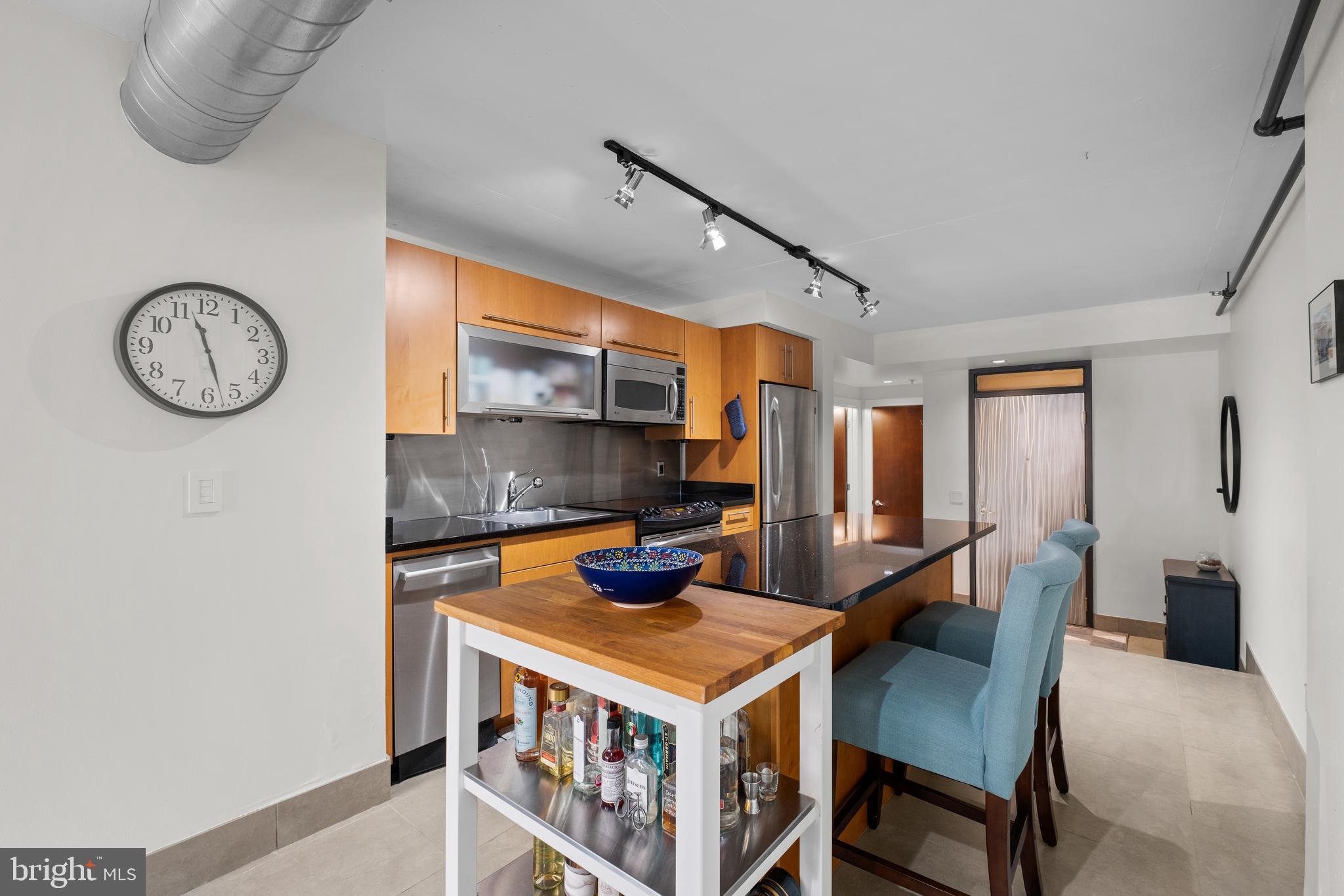 1133 14th Street Northwest, Unit 210 Washington, DC 20005 - Photo 13 of 34 a kitchen with a stove and a clock
