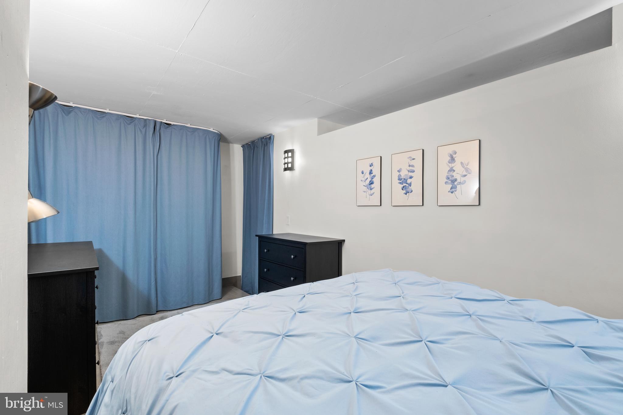 1133 14th Street Northwest, Unit 210 Washington, DC 20005 - Photo 15 of 34 a bedroom with a bed and a painting on the wall