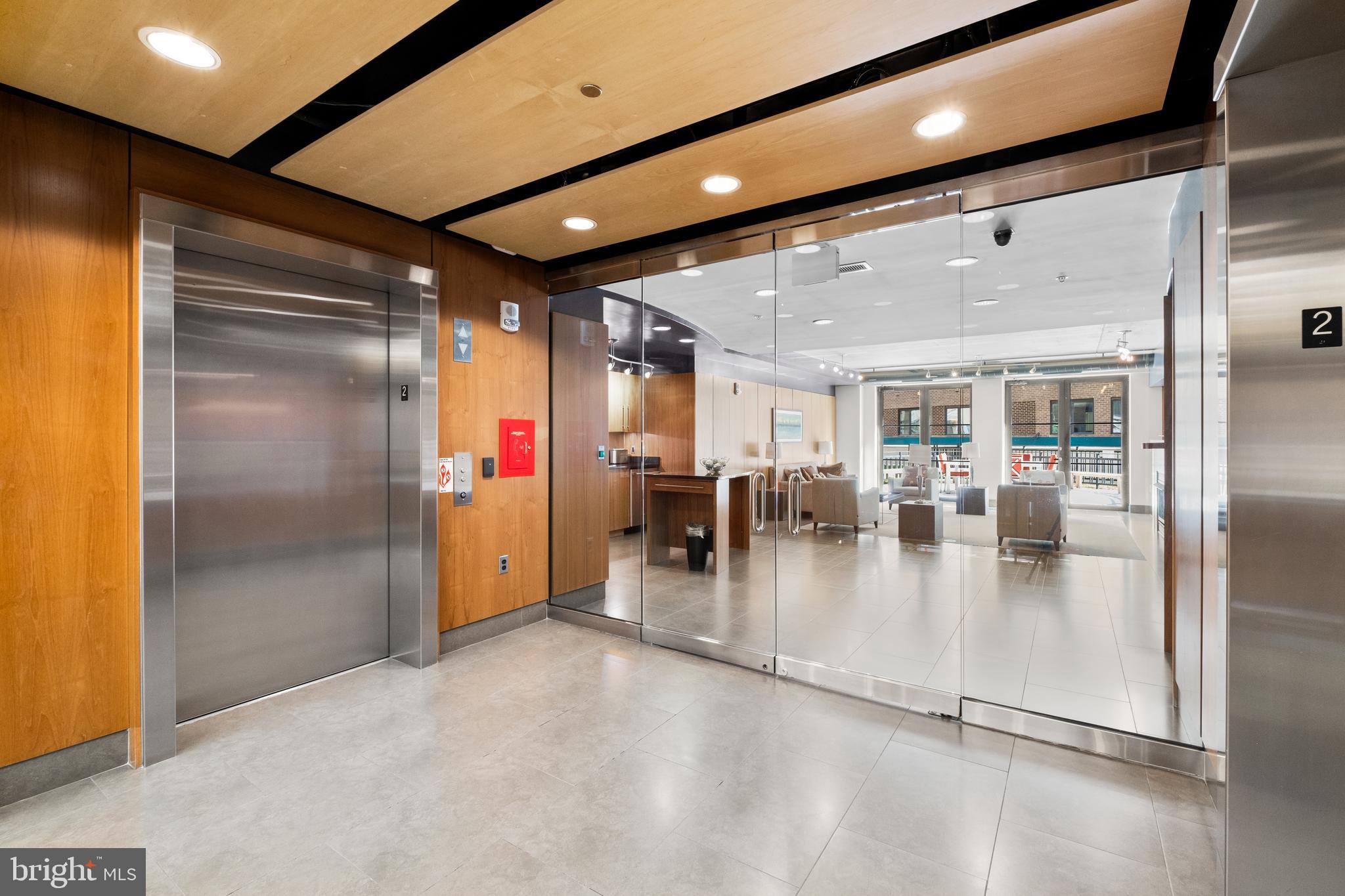 1133 14th Street Northwest, Unit 210 Washington, DC 20005 - Photo 23 of 34 a lobby with a refrigerator and a table