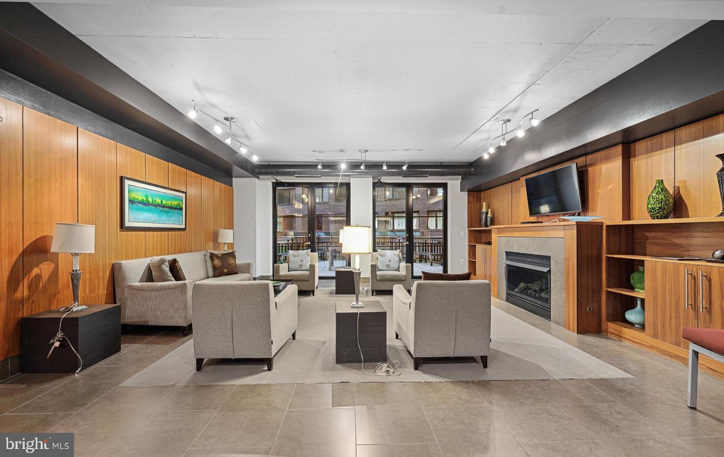 1133 14th Street Northwest, Unit 210 Washington, DC 20005 - Photo 25 of 34 a living room with furniture a fireplace and a flat screen tv