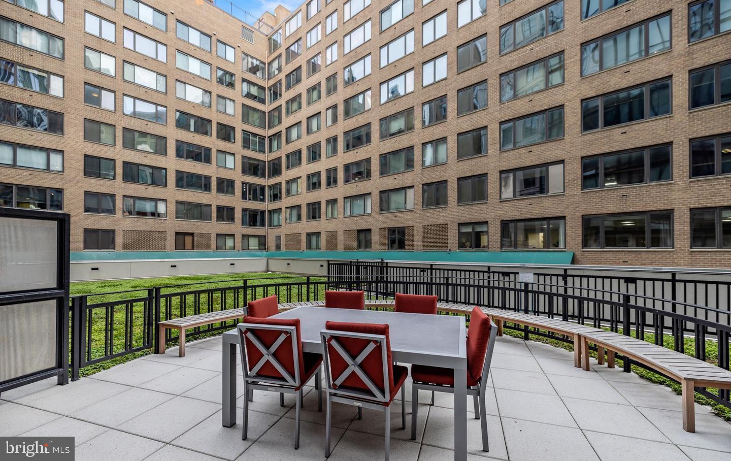 1133 14th Street Northwest, Unit 210 Washington, DC 20005 - Photo 26 of 34 a view of a building from a chairs and table in the balcony