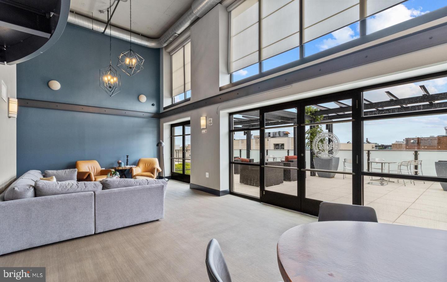 1133 14th Street Northwest, Unit 210 Washington, DC 20005 - Photo 28 of 34 a living room with furniture and a floor to ceiling window