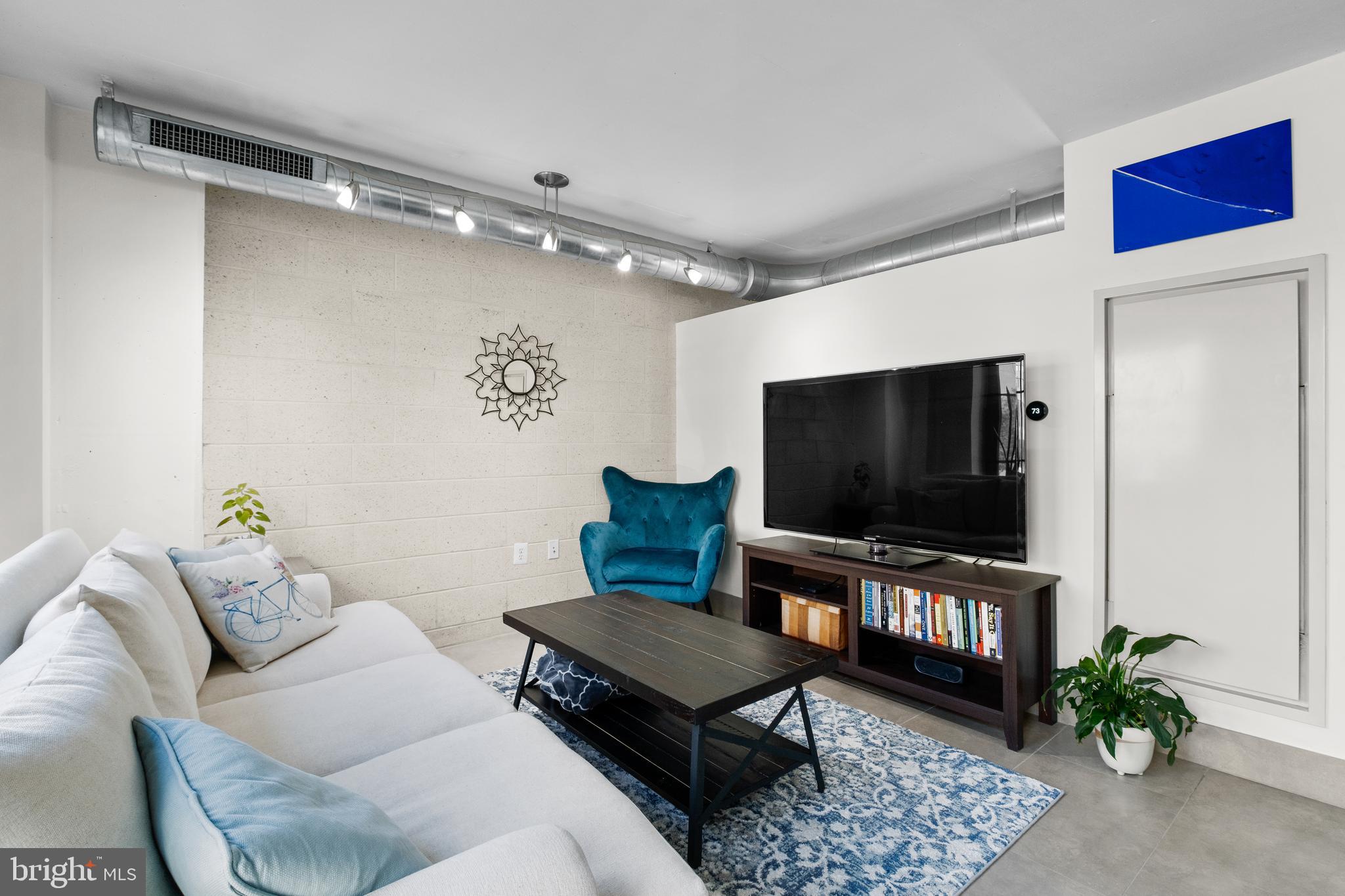 1133 14th Street Northwest, Unit 210 Washington, DC 20005 - Photo 4 of 34 a living room with furniture and a flat screen tv