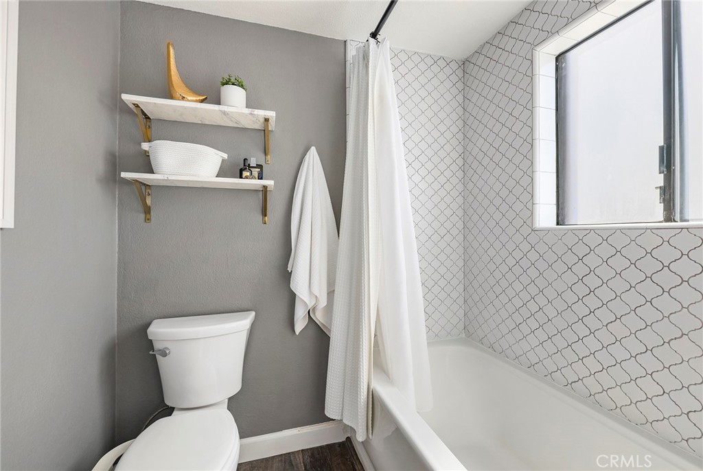 2135 East 4th Street, Unit 202 Long Beach, CA 90814 - Photo 13 of 23 a white toilet sitting next to a bath tub