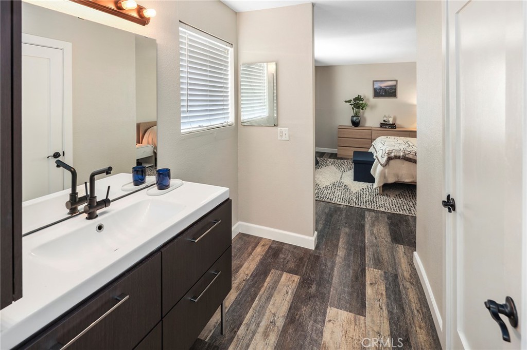 2135 East 4th Street, Unit 202 Long Beach, CA 90814 - Photo 14 of 23 a en suite bathroom with a granite countertop sink and a mirror