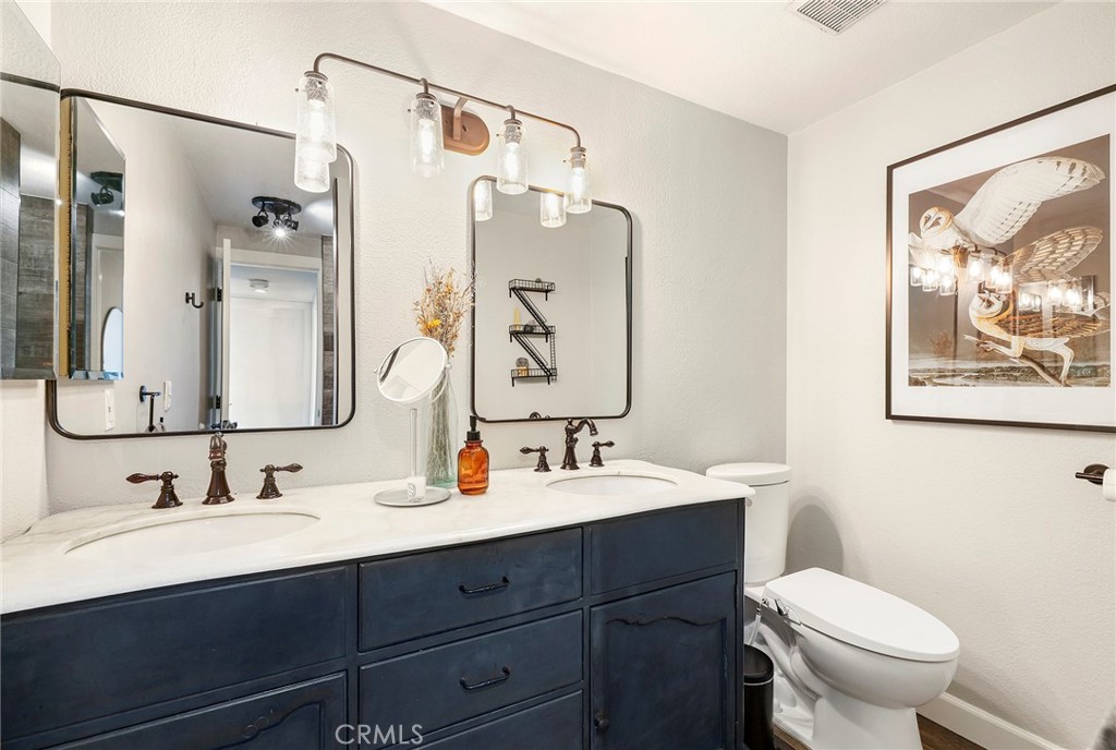2135 East 4th Street, Unit 202 Long Beach, CA 90814 - Photo 16 of 23 a bathroom with a sink vanity mirror and toilet