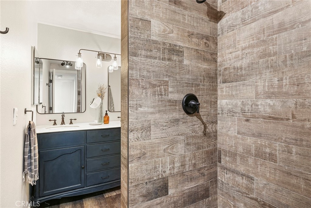 2135 East 4th Street, Unit 202 Long Beach, CA 90814 - Photo 17 of 23 a bathroom with a sink a mirror and shower