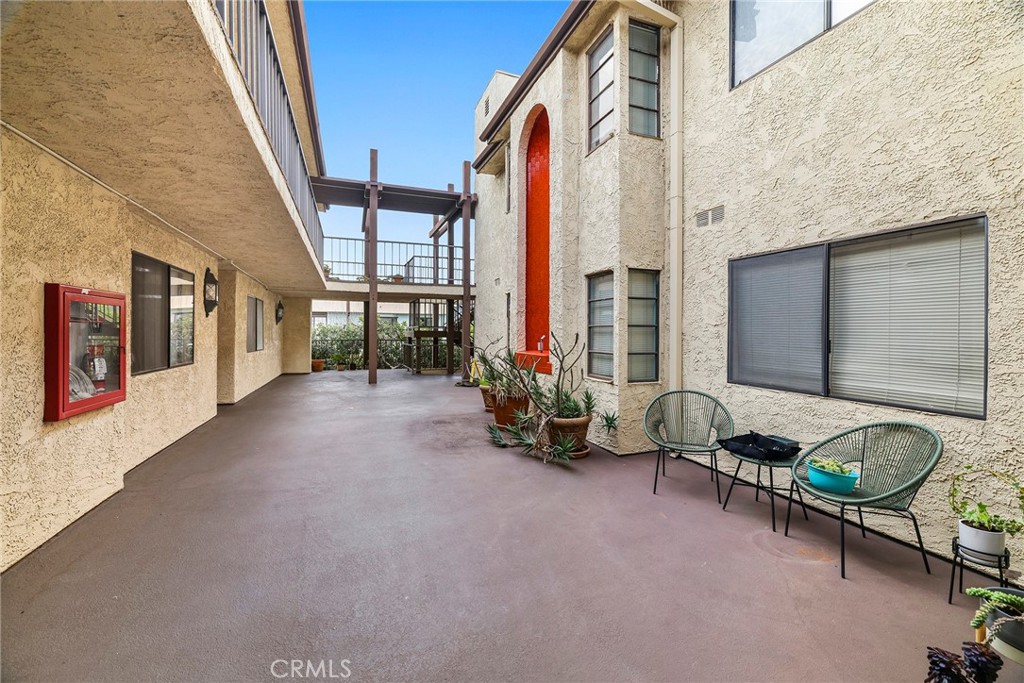 2135 East 4th Street, Unit 202 Long Beach, CA 90814 - Photo 21 of 23 a living room with furniture and a floor to ceiling window