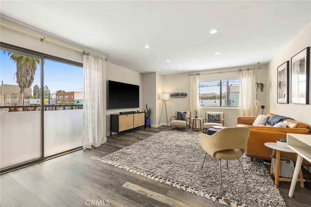 2135 East 4th Street, Unit 202 Long Beach, CA 90814 - Photo 3 of 23 a living room with furniture and a flat screen tv