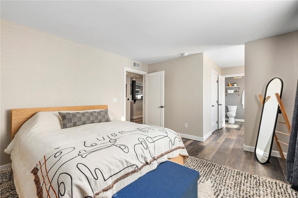 2135 East 4th Street, Unit 202 Long Beach, CA 90814 - Photo 10 of 23 a bedroom with a bed a rug and wooden floor